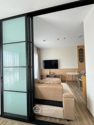 Modern living room with sliding glass doors and cozy beige sofa