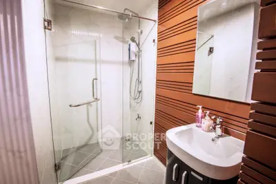 Modern bathroom with glass shower and stylish sink