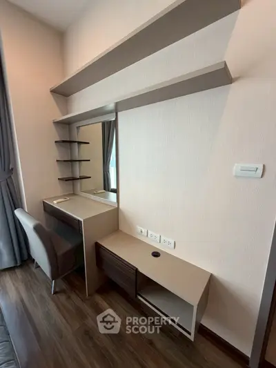 Modern bedroom with stylish vanity and shelves, perfect for urban living.