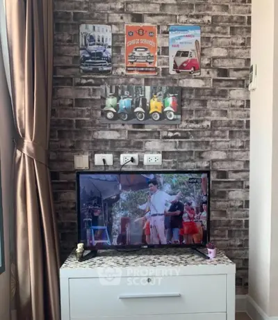 Charming living room with vintage decor and modern TV setup