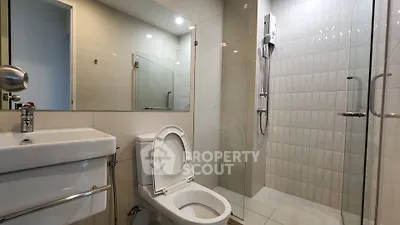 Modern bathroom with sleek fixtures and glass shower enclosure