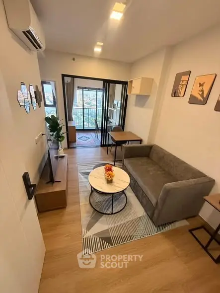 Modern living room with stylish decor and large windows offering natural light.