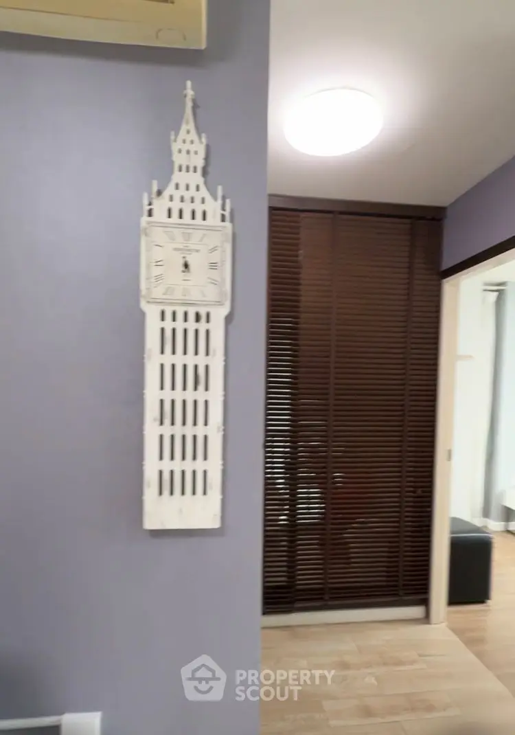 Stylish interior with unique clock and wooden blinds in a cozy living space.