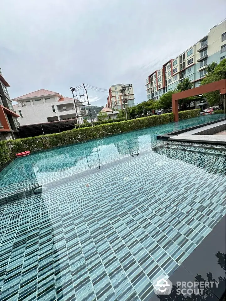 Stunning residential pool with modern design and serene surroundings in a luxury apartment complex.