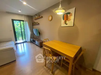 Cozy living room with modern decor and balcony view, perfect for relaxation and entertainment.