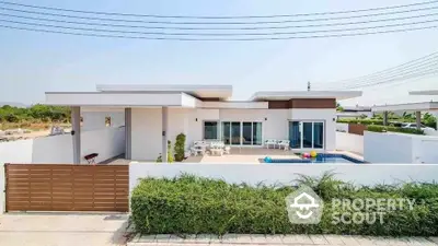 Modern single-story home with pool and spacious patio in a serene neighborhood.