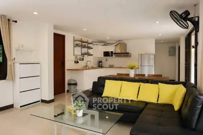 Modern open-plan living room with sleek kitchen and stylish decor