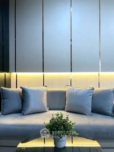 Elegant modern living room with plush gray sofa and stylish lighting