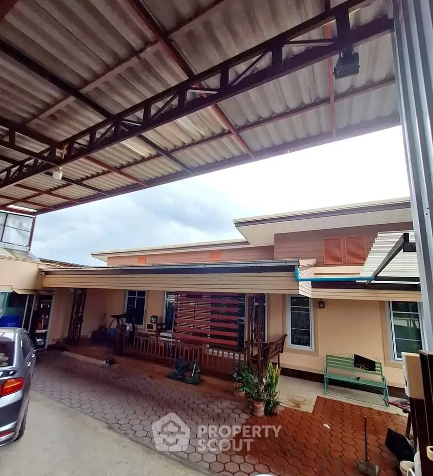 Spacious residential property with covered parking and outdoor seating area.