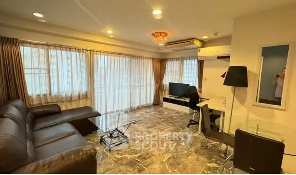 Spacious living room with modern furniture and large windows offering ample natural light.