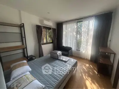 Bright and airy bedroom with modern furnishings and large windows