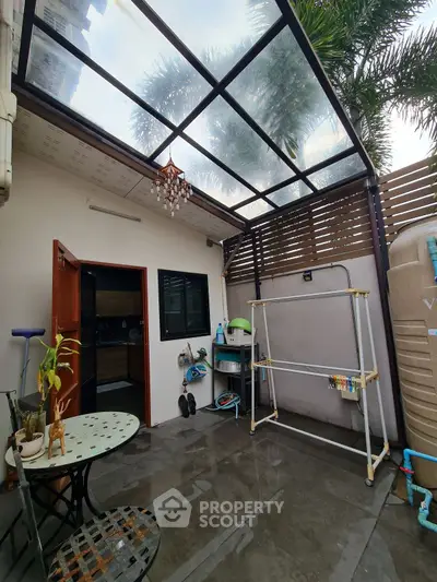 Charming outdoor patio with transparent roof and cozy seating area, perfect for relaxation and entertaining.