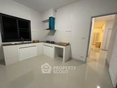 Modern kitchen with sleek design and gas stove in a spacious apartment.