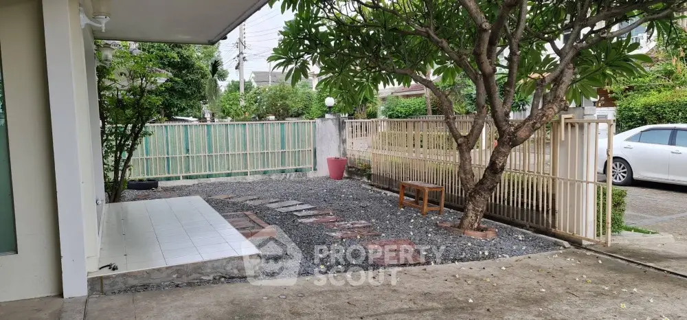 Charming garden area with tree and stepping stones in a serene residential setting