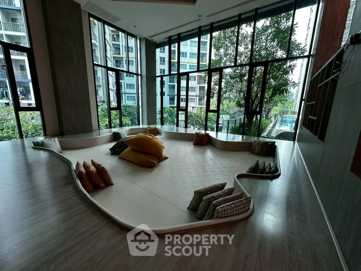 Luxurious modern lounge area with floor-to-ceiling windows and city view