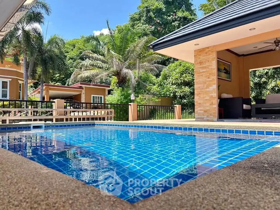 Luxurious villa with private pool and lush garden, perfect for tropical living.
