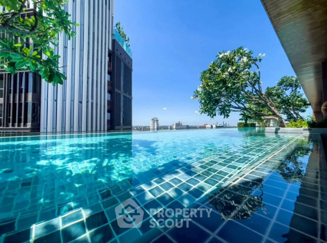 Luxurious rooftop pool with stunning city view and lush greenery