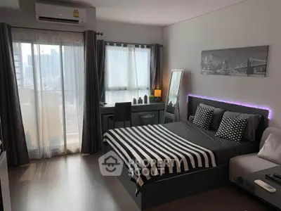 Modern bedroom with stylish decor and city view, featuring a comfortable bed and sleek furnishings.