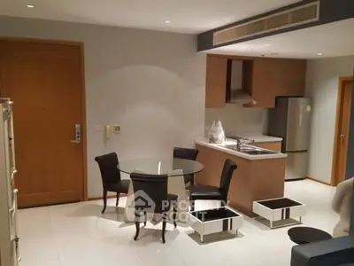 Modern kitchen and dining area with sleek design and stainless steel appliances.