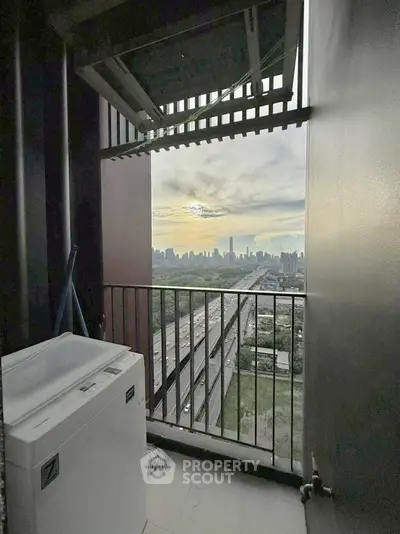 High-rise balcony with washing machine and stunning city skyline view