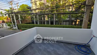 Spacious balcony with modern tiles and lush greenery view