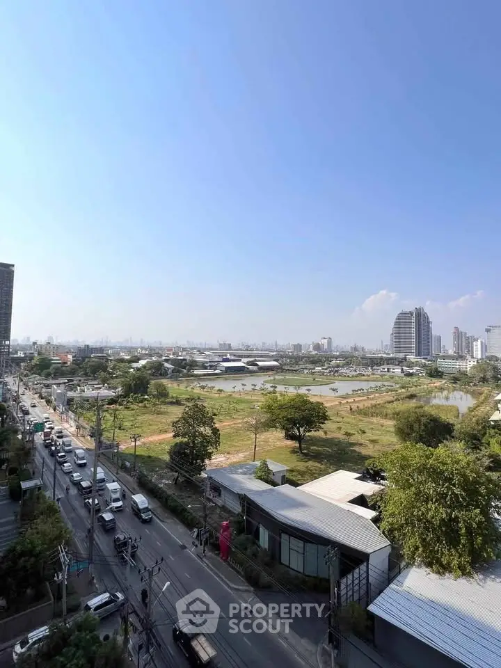 Stunning cityscape view with lush greenery and modern buildings, perfect for urban living enthusiasts.