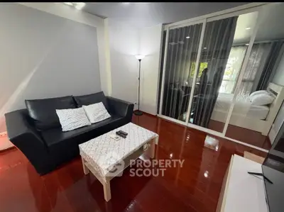 Modern living room with sleek design and cozy bedroom view