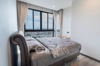 Modern bedroom with city view, featuring a plush bed and large window for natural light.