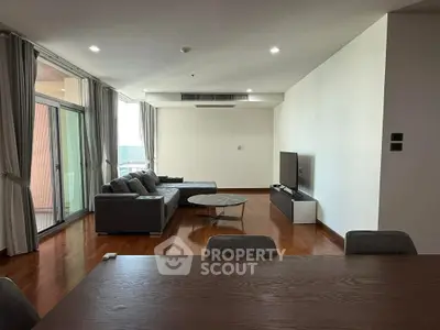 Spacious modern living room with large windows and stylish furniture