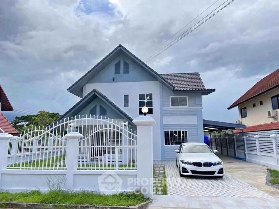 Charming two-story house with a modern design, spacious driveway, and lush green lawn, perfect for family living.