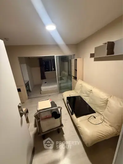 Cozy apartment interior with living room and bedroom, featuring modern furniture and open layout.