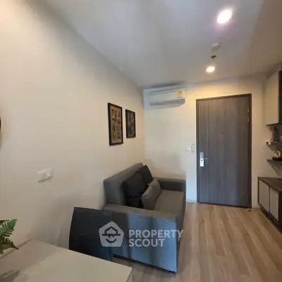 Modern living room with sleek design, featuring a comfortable sofa and stylish decor, perfect for urban living.