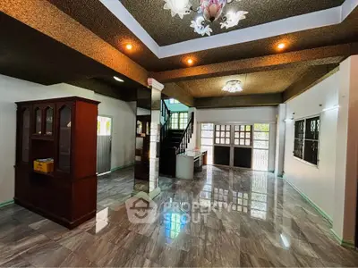 Spacious living room with elegant lighting and glossy flooring in a modern home.