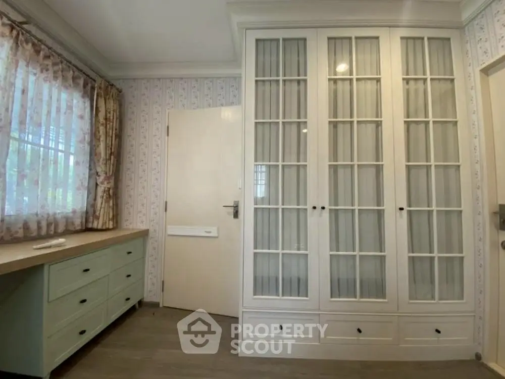 Charming bedroom with elegant built-in wardrobe and natural light