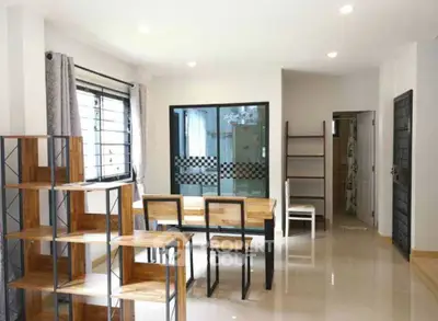 Modern living room with stylish wooden furniture and large window