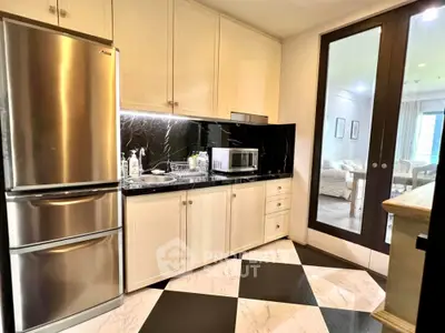 Modern kitchen with sleek appliances and elegant black and white flooring