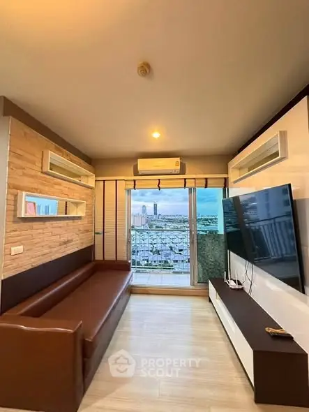 Modern living room with city view, large TV, and stylish decor.