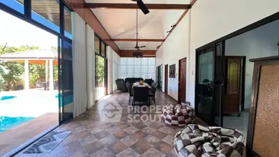 Spacious living area with pool view and modern decor in luxury home