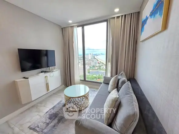 Modern living room with stunning city view, featuring elegant decor and large windows.