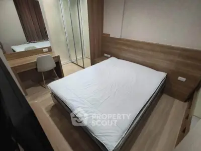 Modern bedroom with sleek wooden furniture and a cozy bed, perfect for relaxation.