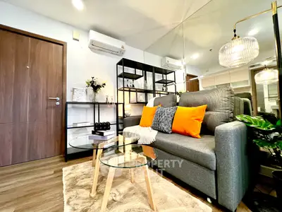 Modern living room with stylish decor, cozy sofa, and elegant lighting