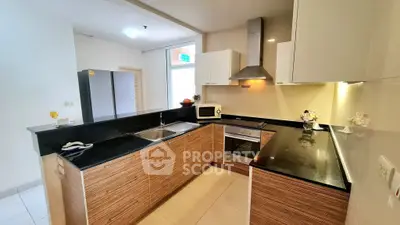 Modern kitchen with sleek countertops and built-in appliances in a stylish open layout.