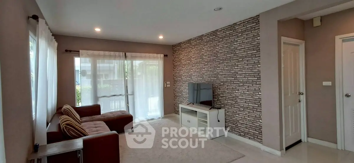 Spacious living room with modern decor and large windows for natural light.