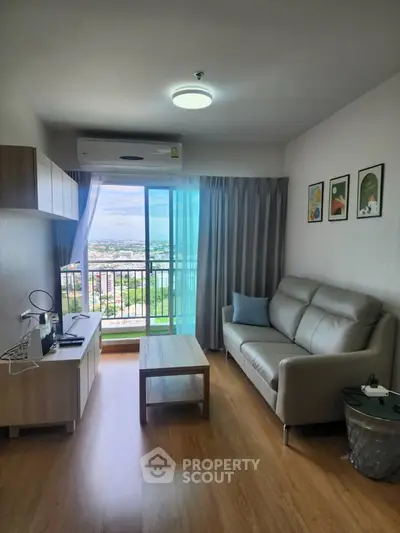 Modern living room with balcony view, stylish furniture, and natural light.