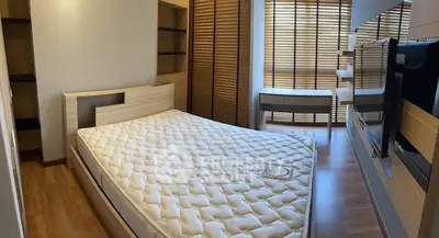 Modern bedroom with stylish wooden accents and large windows for natural light.