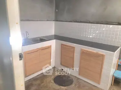 Compact kitchen with minimalist design and tiled backsplash