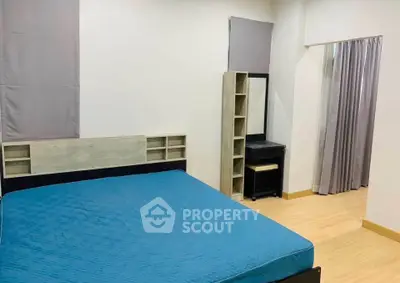 Spacious bedroom with modern decor and ample natural light