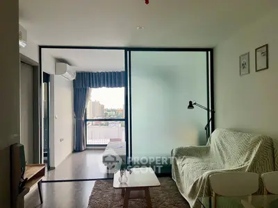 Modern living room with frosted glass divider and city view