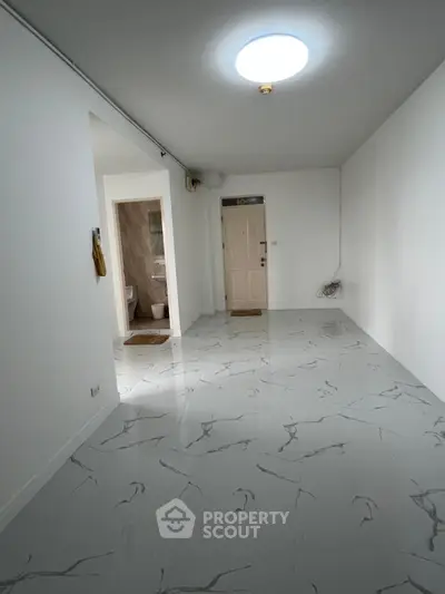 Spacious modern hallway with marble flooring and bright lighting