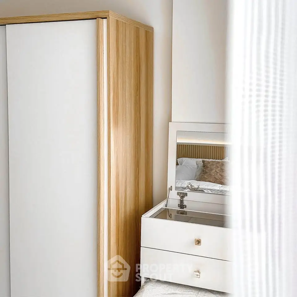 Modern bedroom with stylish wardrobe and elegant vanity mirror
